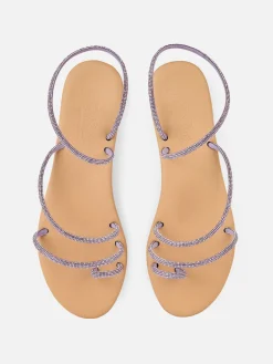 Flache Ringsandalen mit lila Strasssteinen