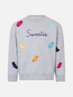Weißes Mädchen-Sweatshirt mit Rundhalsausschnitt und Süßigkeiten-Aufnähern
